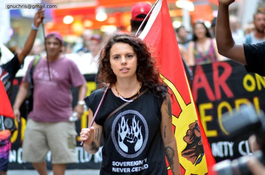 Sovereignty never ceded. Three words on a shirt. Photographed in the middle of a march, they carry the weight of two hundred and fifty years.
