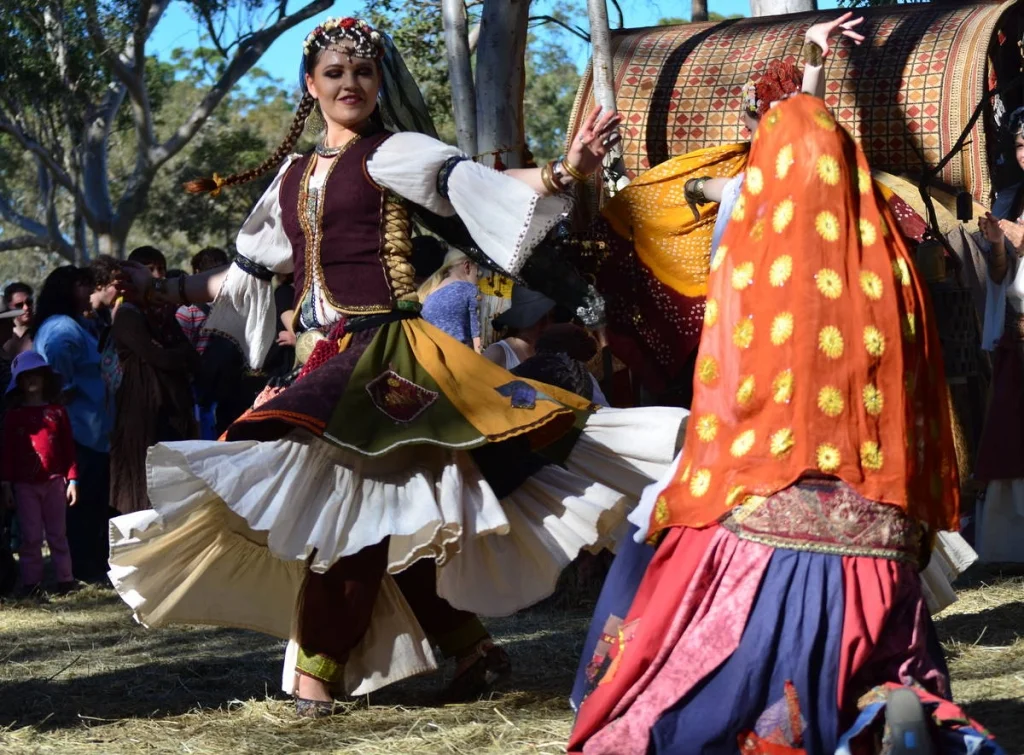 The dancers arrive when the light drops and the crowd thins. By that point the day has a different feeling entirely.