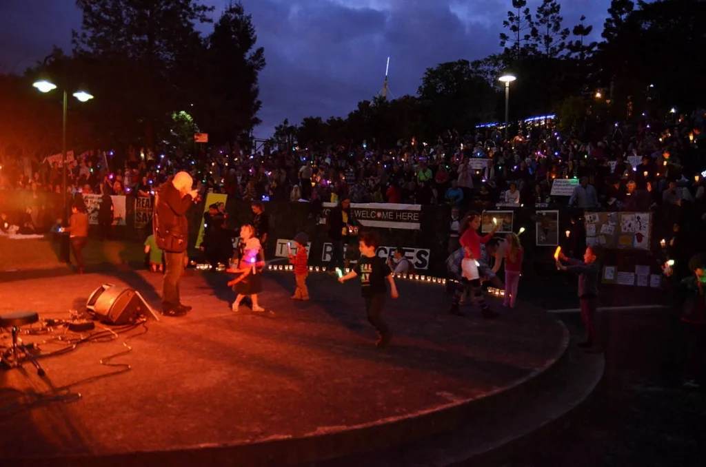 Children dancing in front of a stage that said 'Welcome Here'. The most uncomplicated image of the night and also the most accurate.