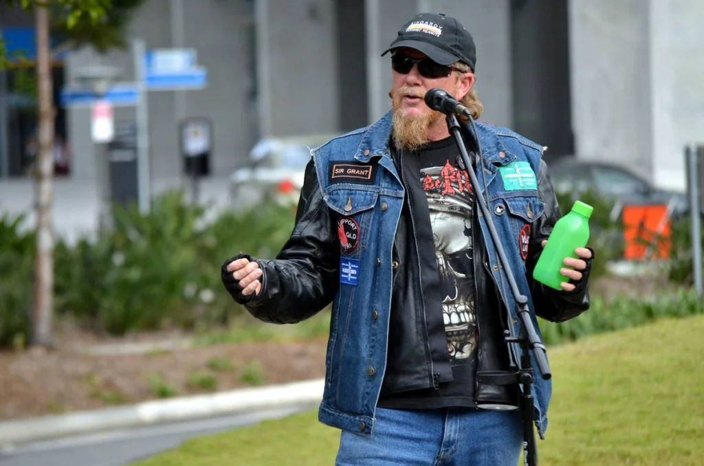 Every patch on that vest is a story. He wore them all to the podium and spoke with the same weight.
