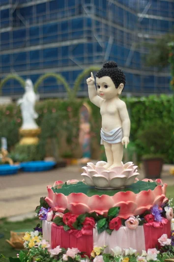The baby Buddha on the lotus stands in every year's display. I keep photographing it from different angles. It keeps rewarding the effort.