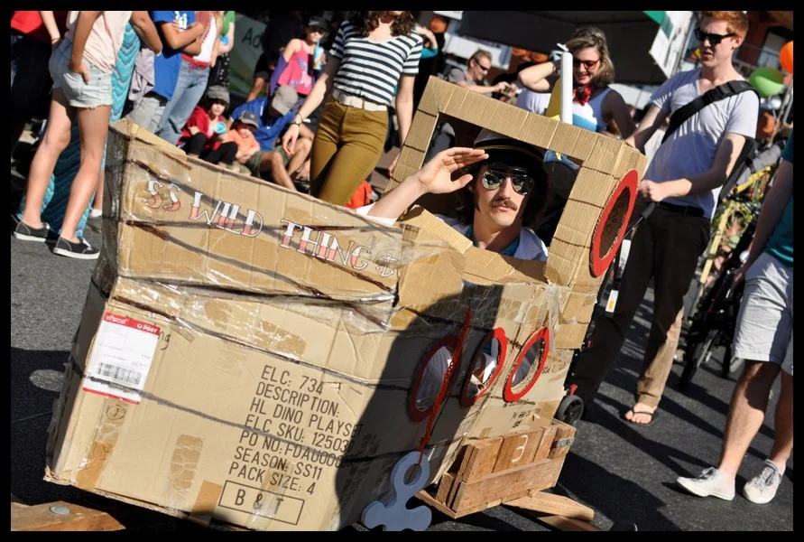 SS Wild Thing — handmade cardboard hull, captain's hat, salute to the crowd. The rules of the Kurilpa Derby are different from other events.