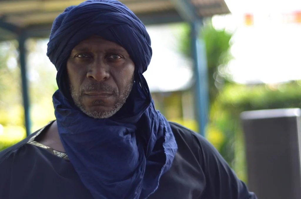 Blue turban, direct eye contact, nothing soft in the expression. A portrait made in two seconds that has stayed with me since.