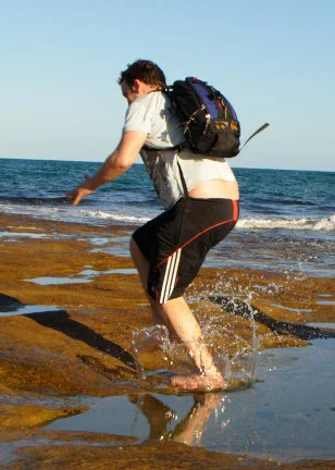 Mid-jump, backpack swinging, water catching the light. This is what the end of an afternoon looks like when nobody is tired yet.