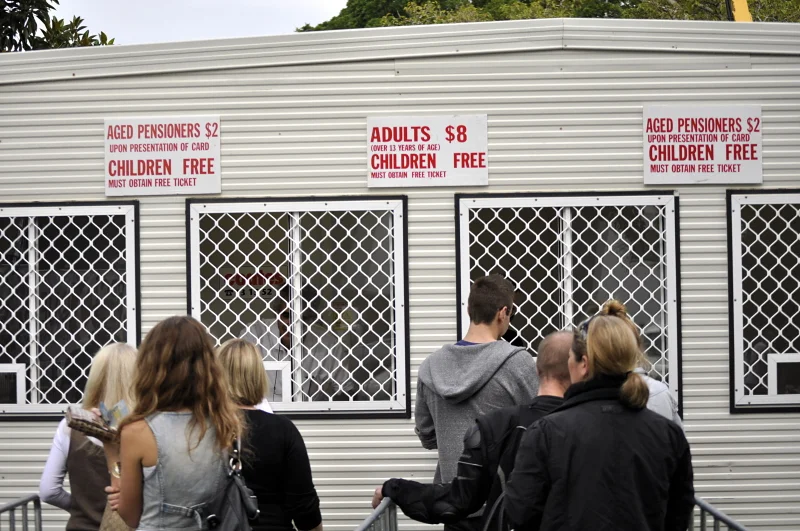 The queue at the ticket booth is the beginning of the story. Everyone is still outside, still in their ordinary life. In ten minutes that will change.